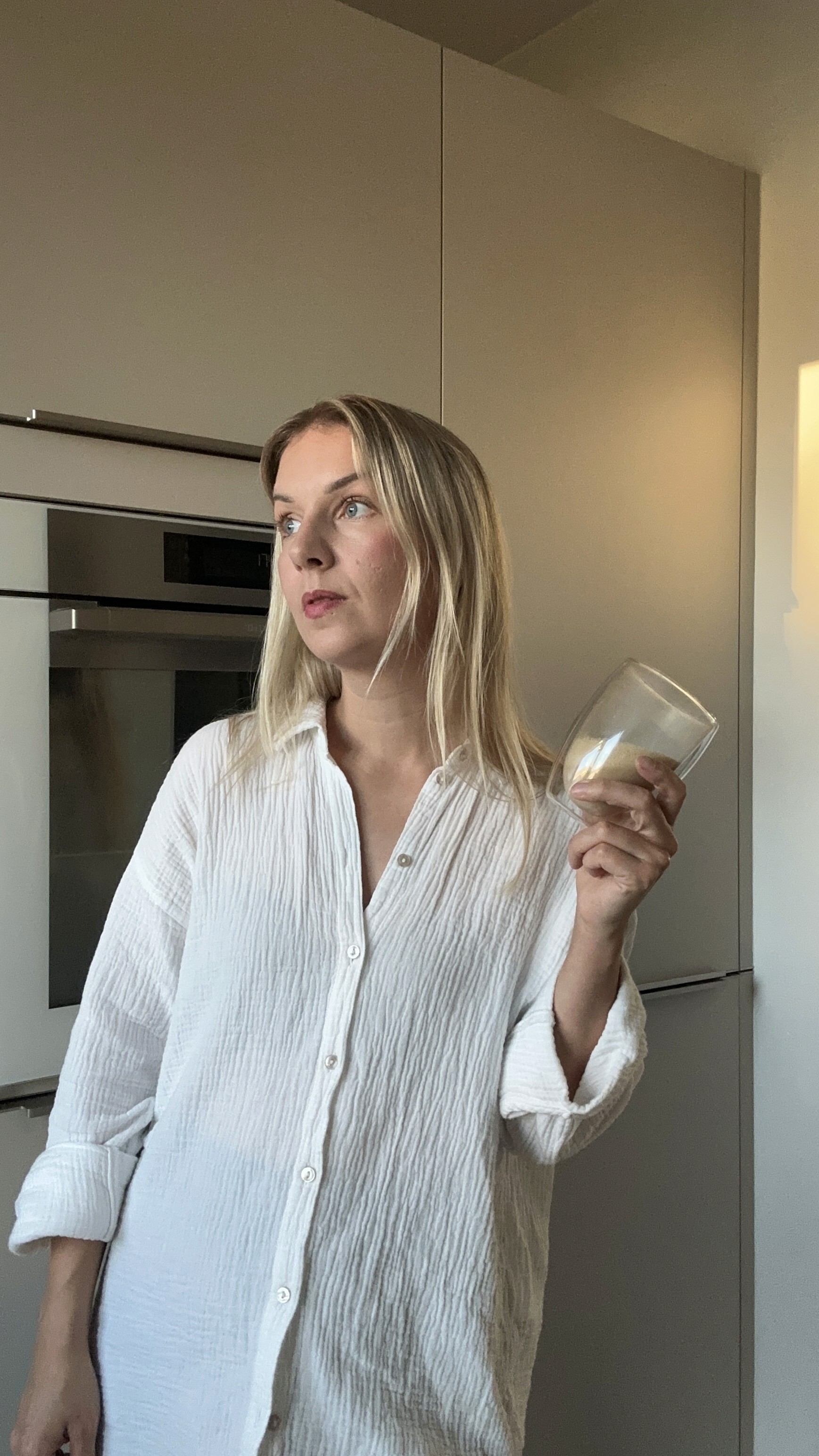 A cozy scene with warm sunlight casting stripes, featuring a potted plant and soft towels on a window sill.
