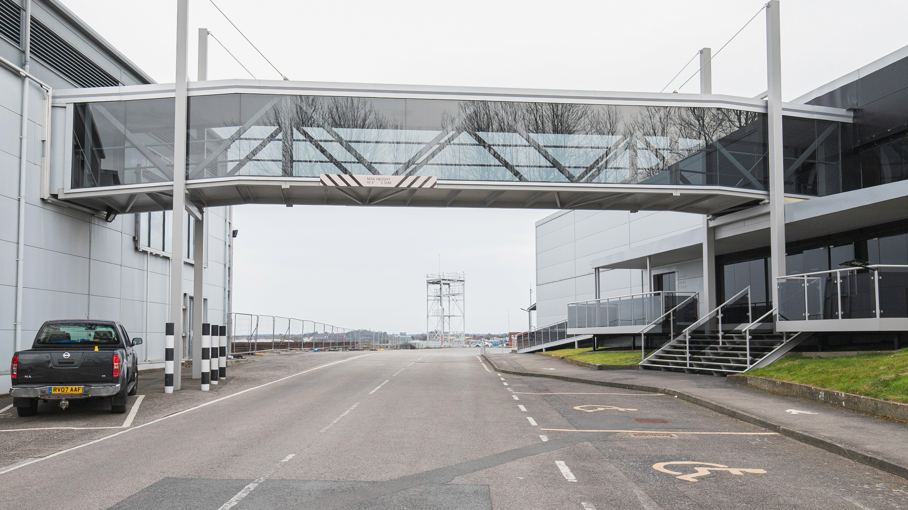 Two classic volkswagen beetles, one green, one cream.