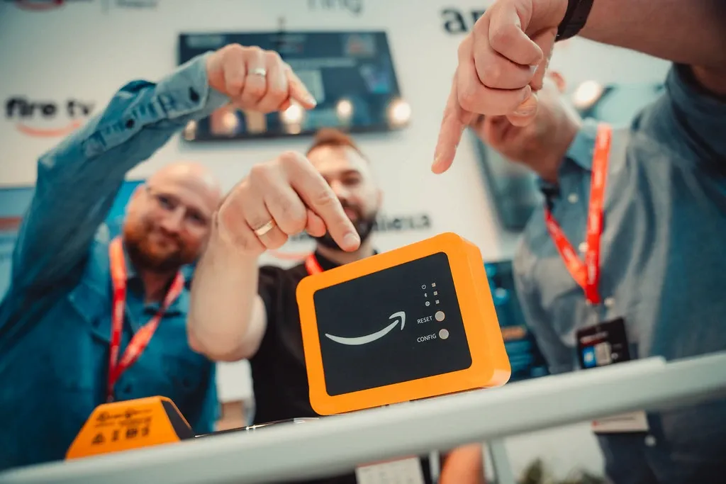 Amazon Polska event stand, conference attendees trying out an Amazon device