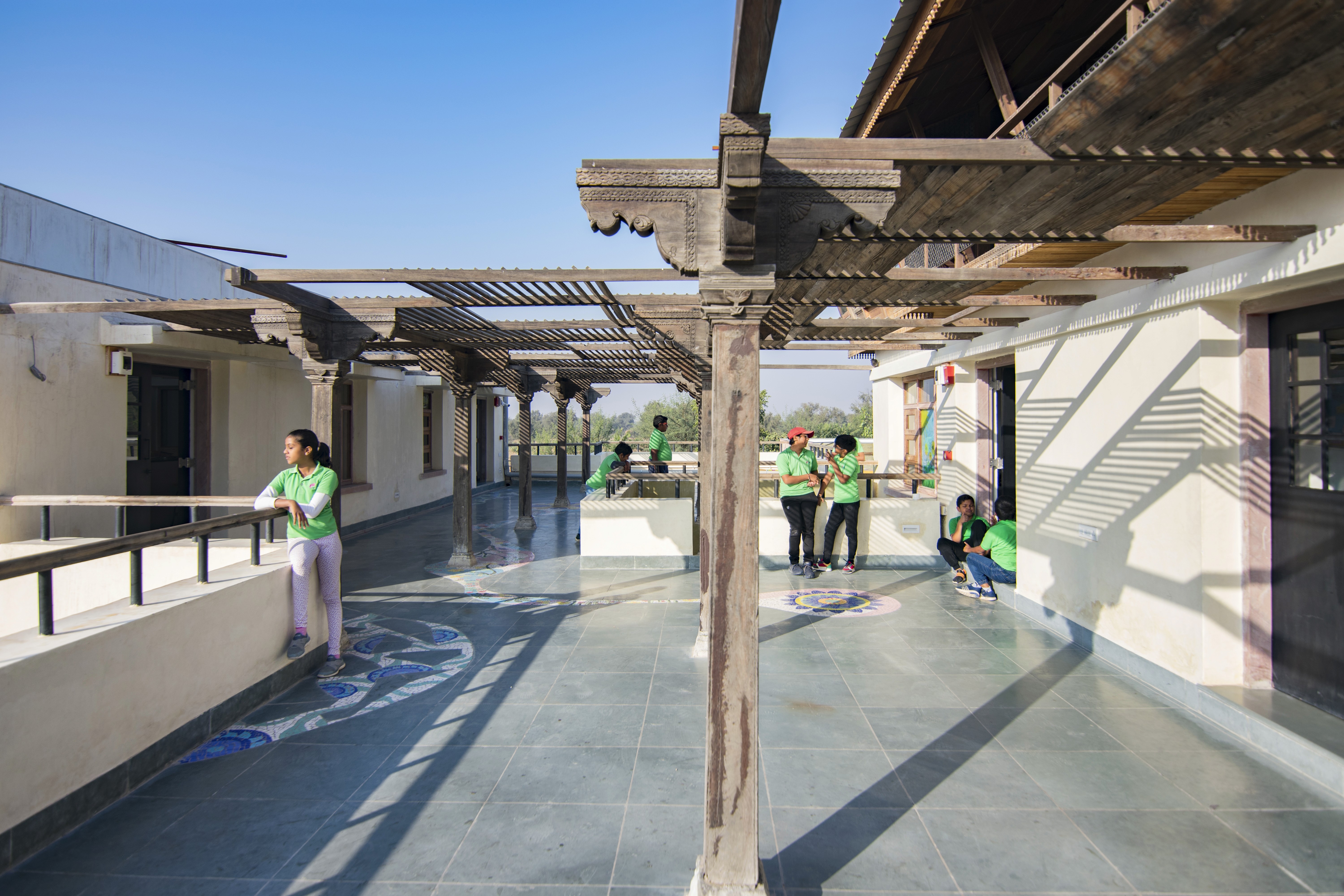 A teacher is explaining a topic to the class, speaking with gestures to emphasize points