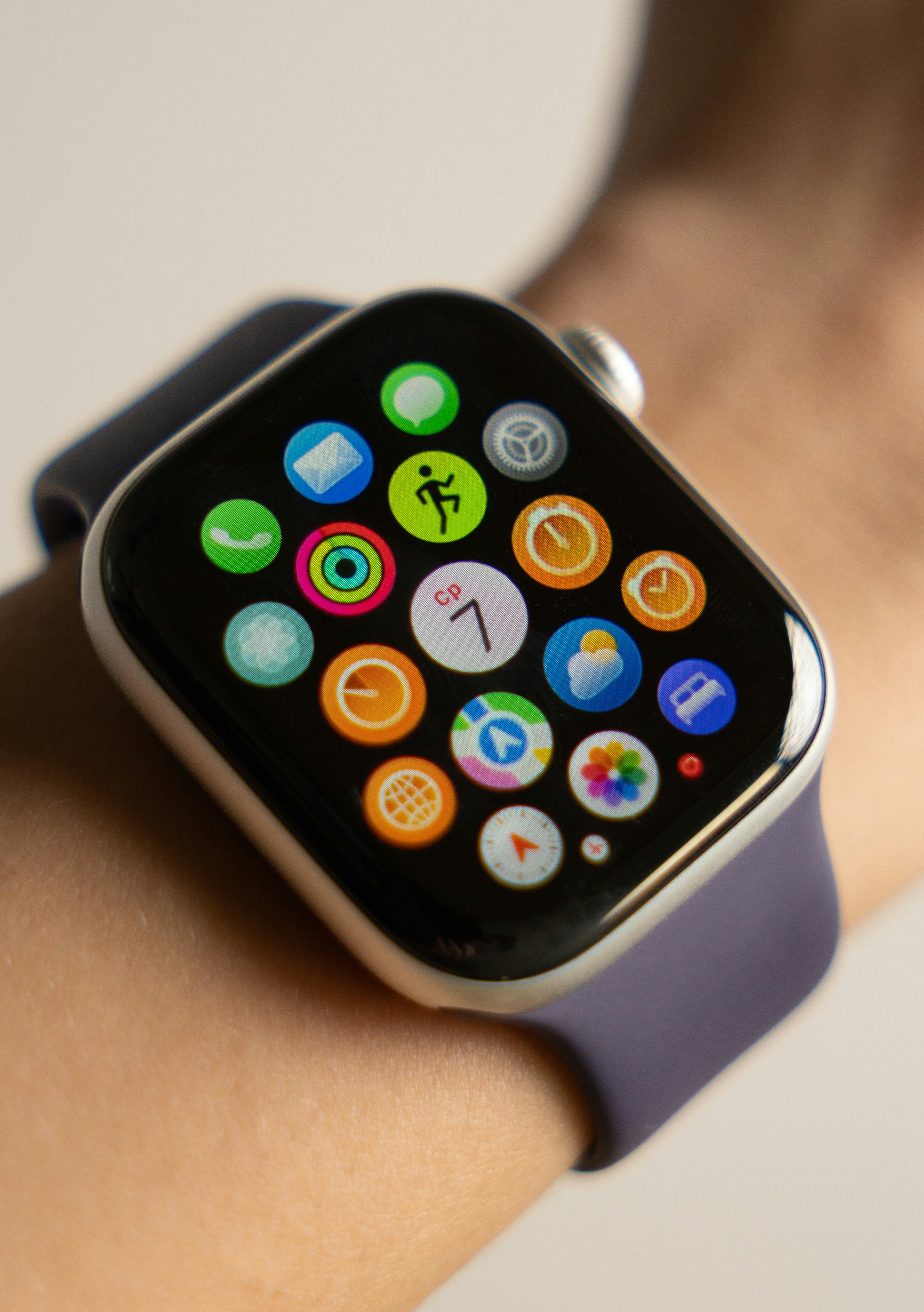 Smartwatch with colorful app icons on screen.