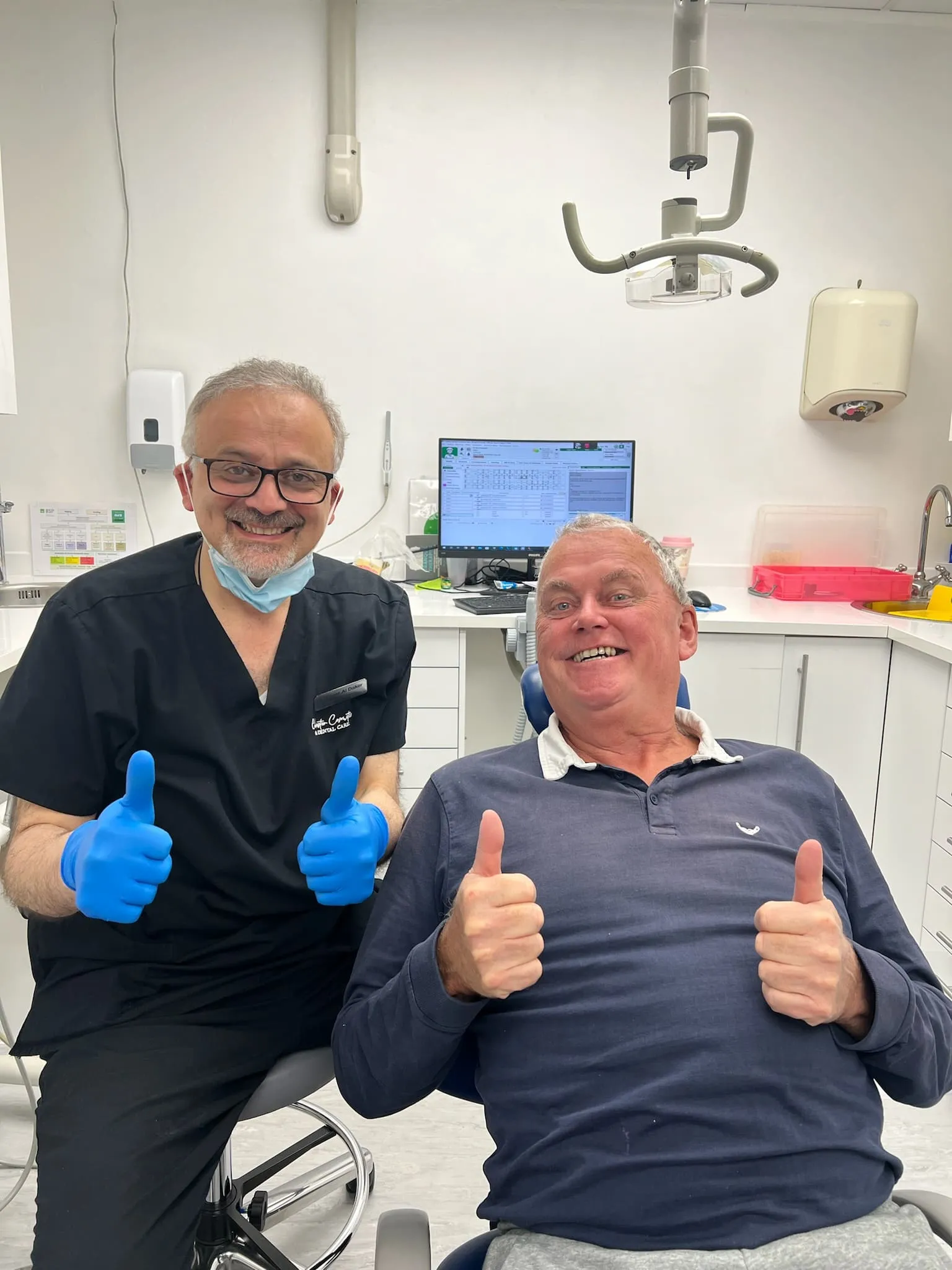 Dr Yasser and his happy patient both smiling and putting their thumbs up.