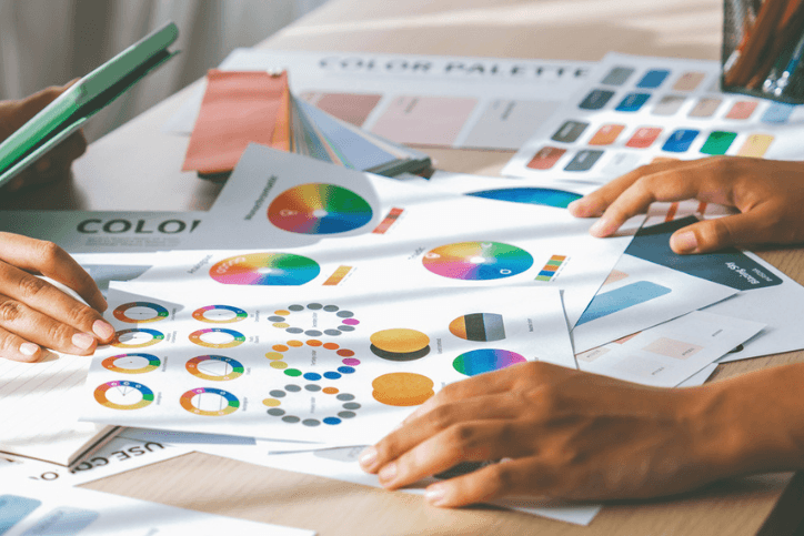 Person holds tablet while selects color from color wheel