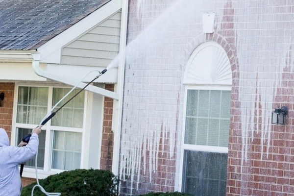 A person cleaning wall with white soap