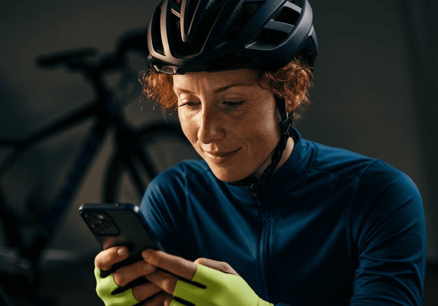 A cyclist in a black helmet and blue jersey