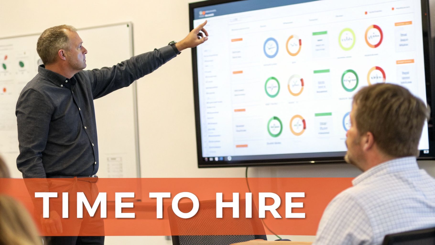 A man points at a large screen showing hiring metrics, with 'TIME TO HIRE' text overlay.