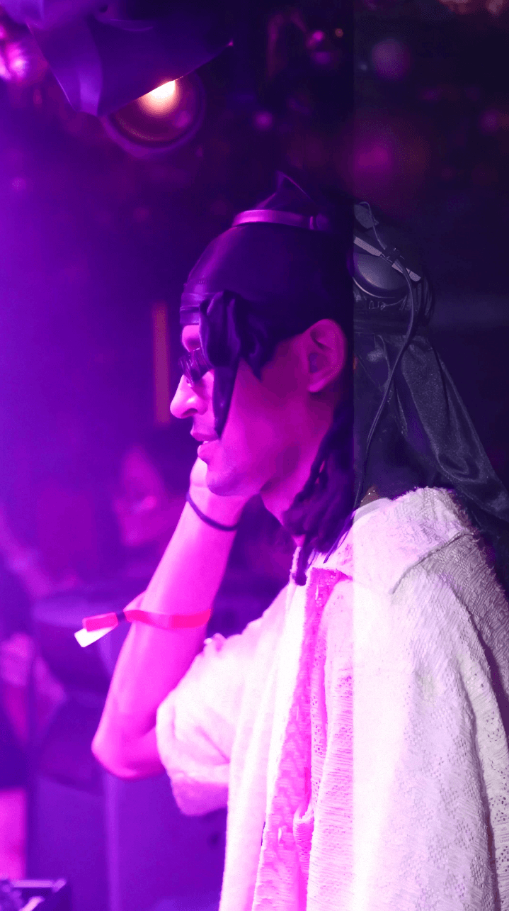 Dancer in black outfit with one leg raised behind