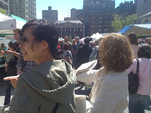A photo of a group of people distributing flyers on the street.
