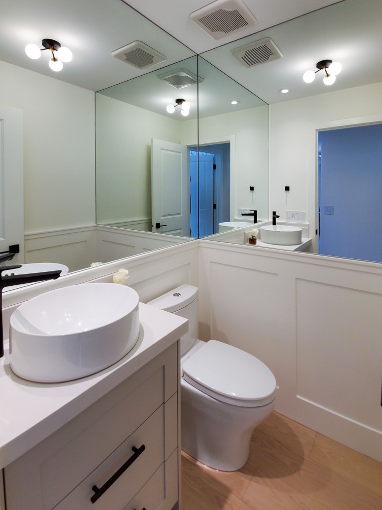 Image of Modern bathroom interior with KHD Homes design-build primary ensuite featuring white fixtures and large mirror.