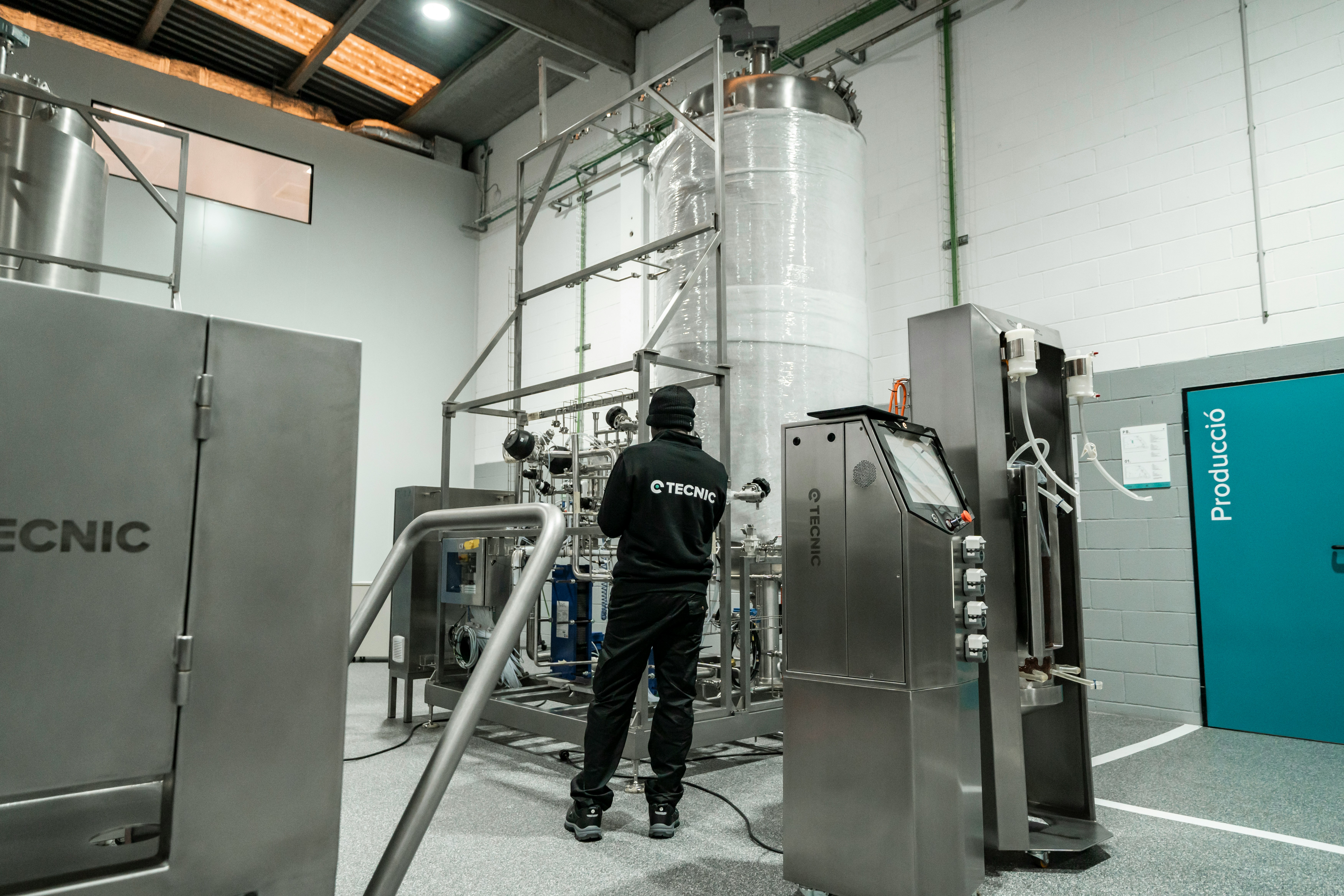 A person works with industrial equipment.
