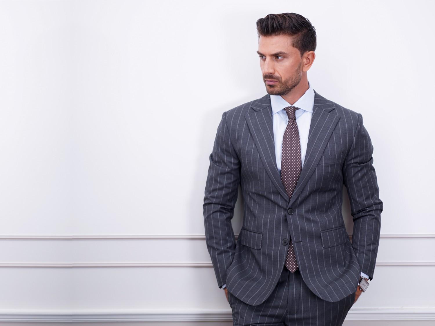 Grey tailored suit styled for professional menswear in Dubai.