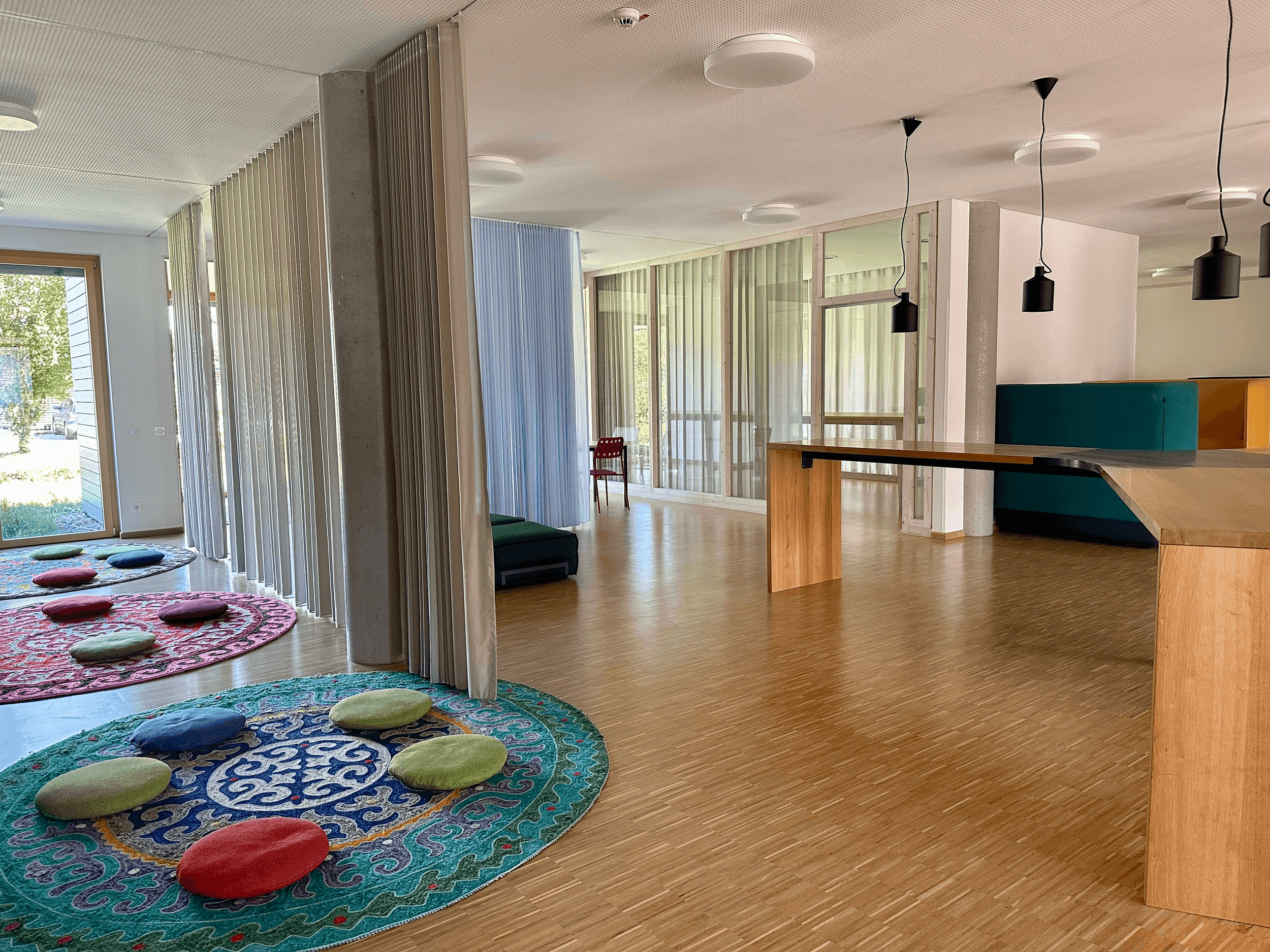 School facilities with open spaces and carpets and cushions on the floor