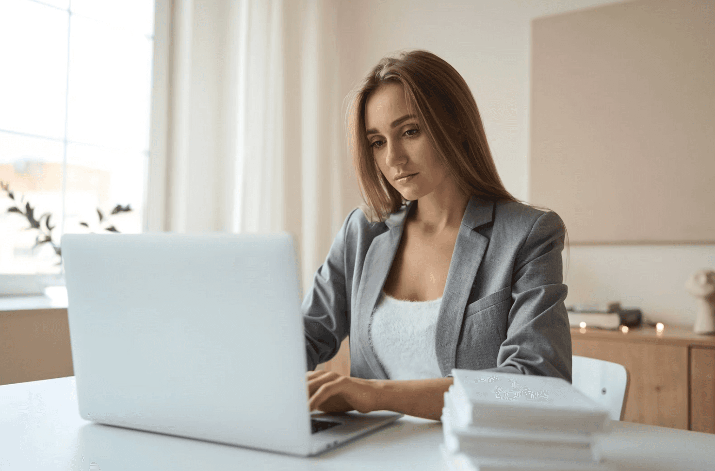 Marketer analysing Amazon Ads search terms on a laptop to spot internal cannibalisation between overlapping campaigns