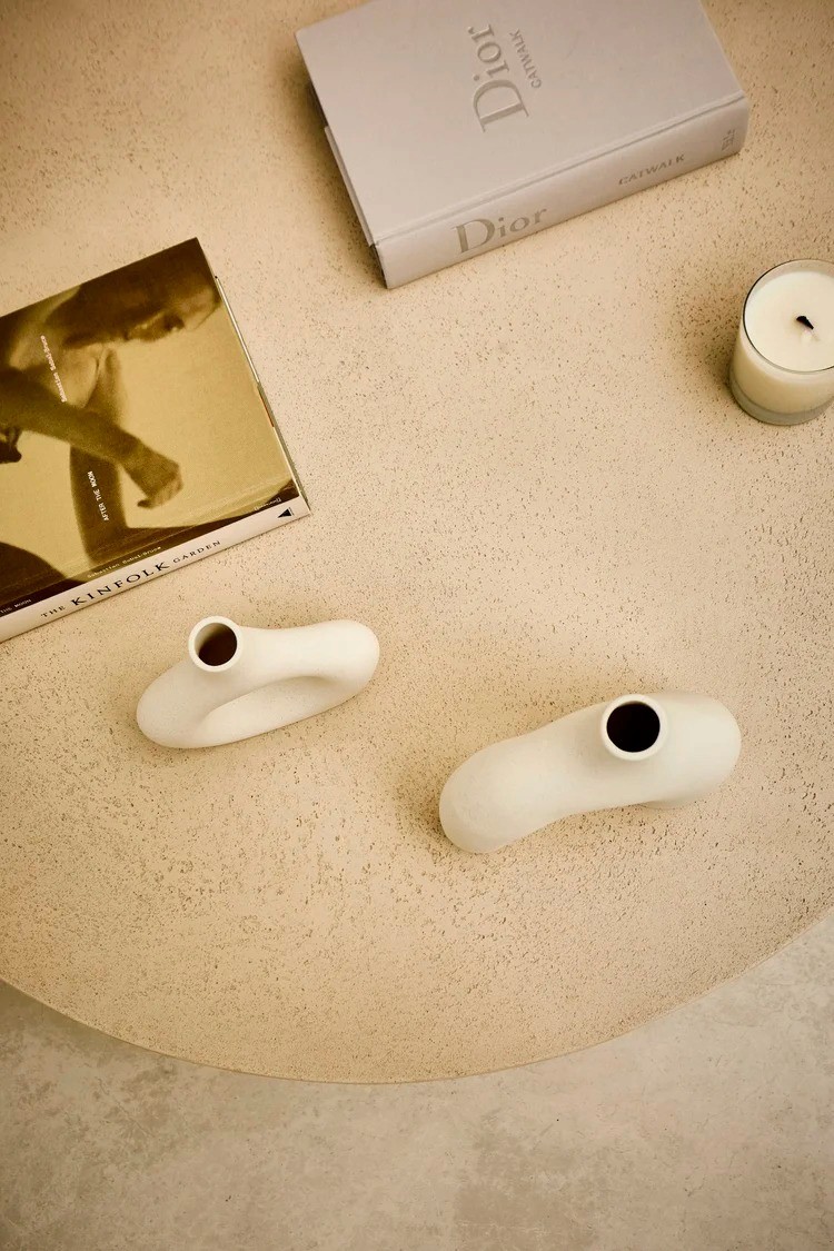 Neutral-toned coffee table styling with ceramic decor and design books in Terra Dental NYC waiting area.