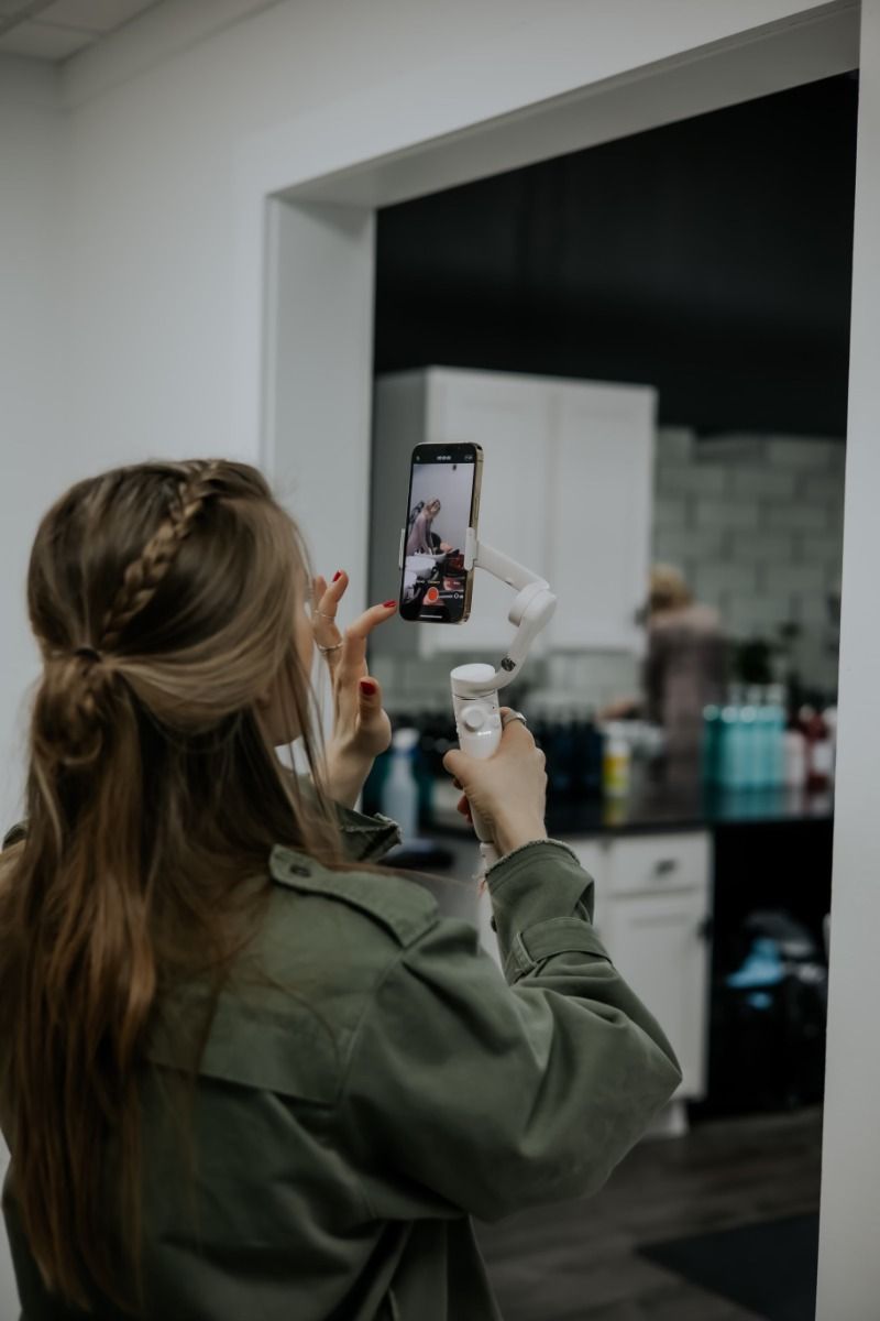 Person in fog with a glowing, glitching computer monitor head, dark cyberpunk portrait.