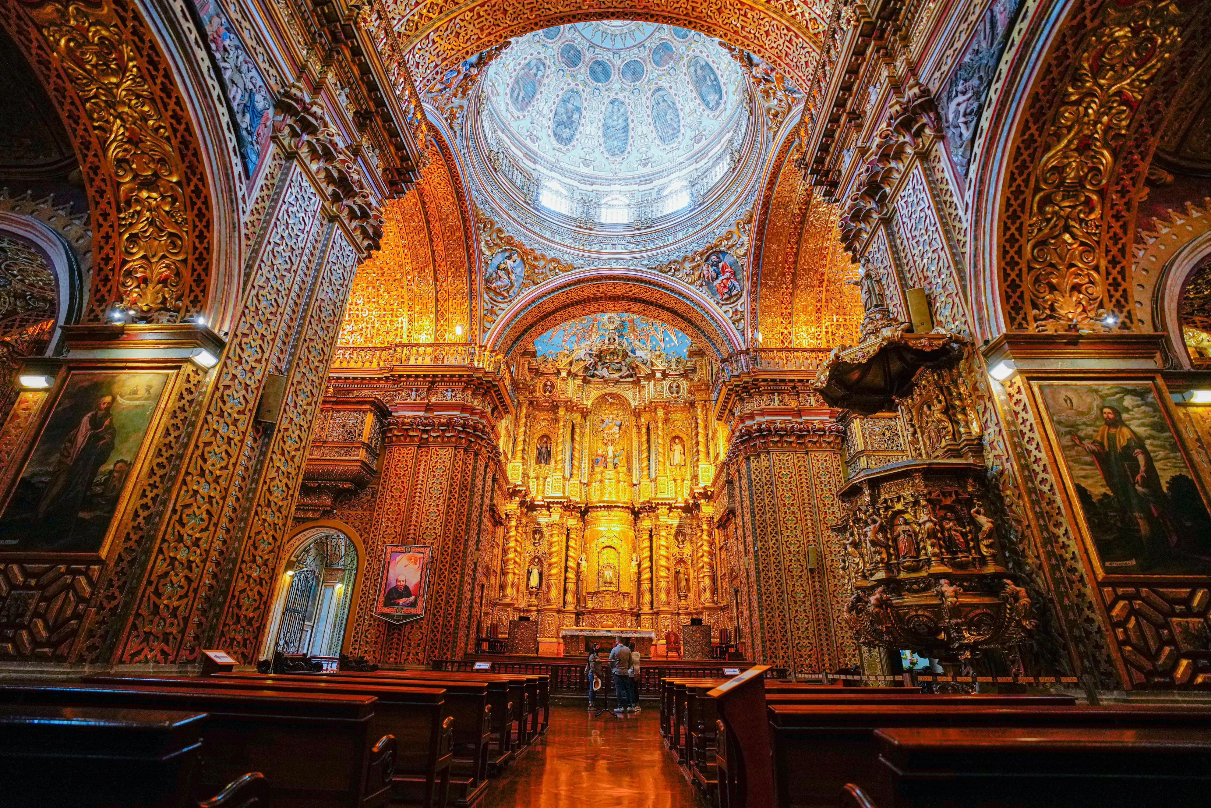 the interior of an ornate church with gold and white decor