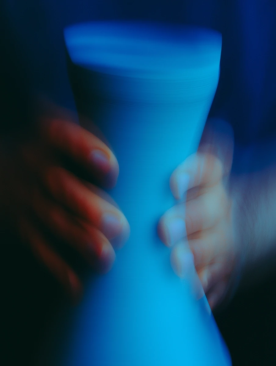 A lone figure stands on a vast beach at sunset.