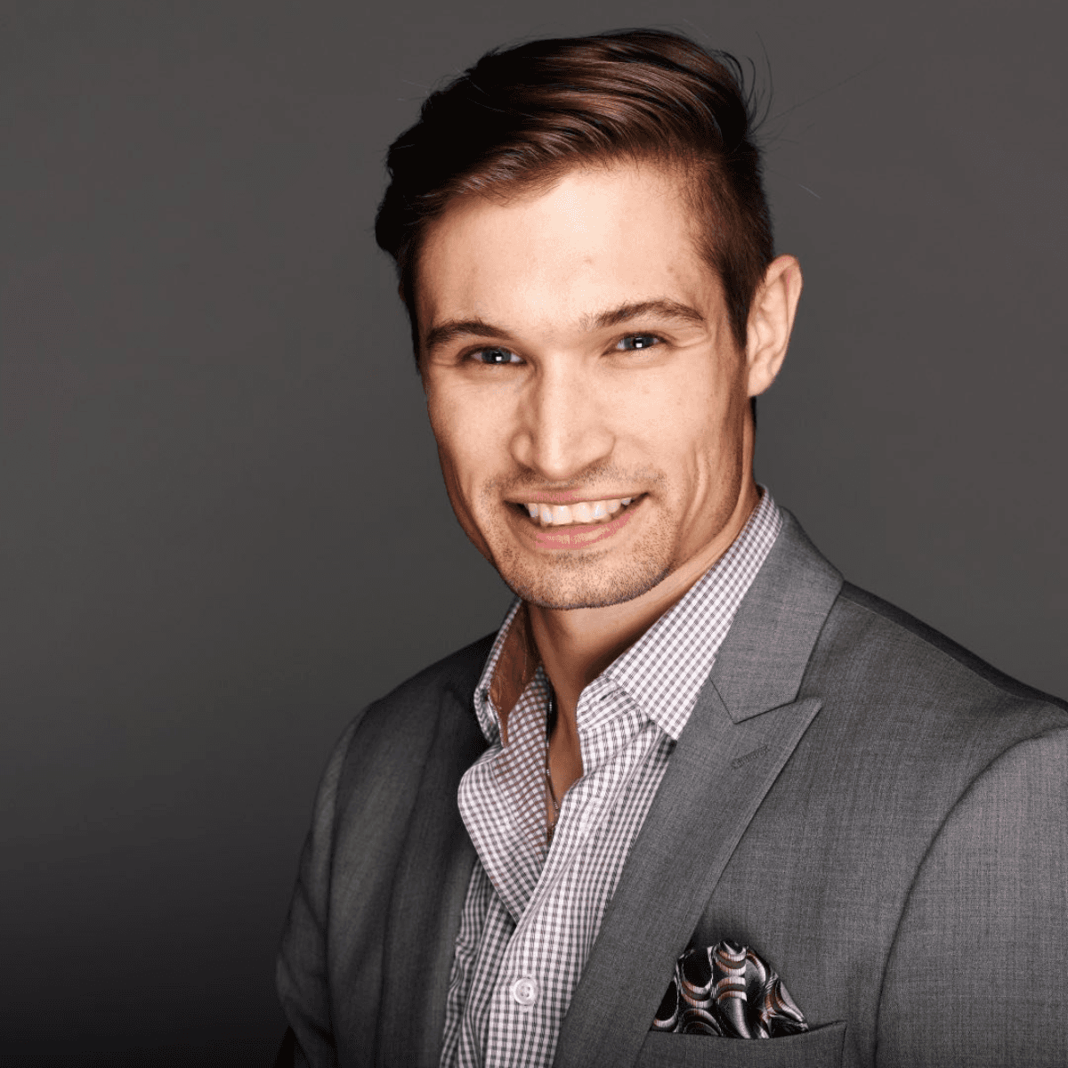 smiling woman wearing white and black pinstriped collared top