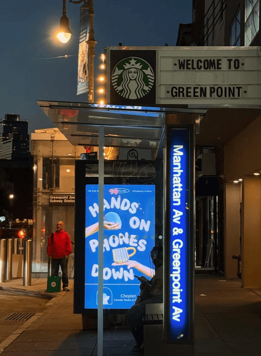 Neon blue sign photographed at night on a city street