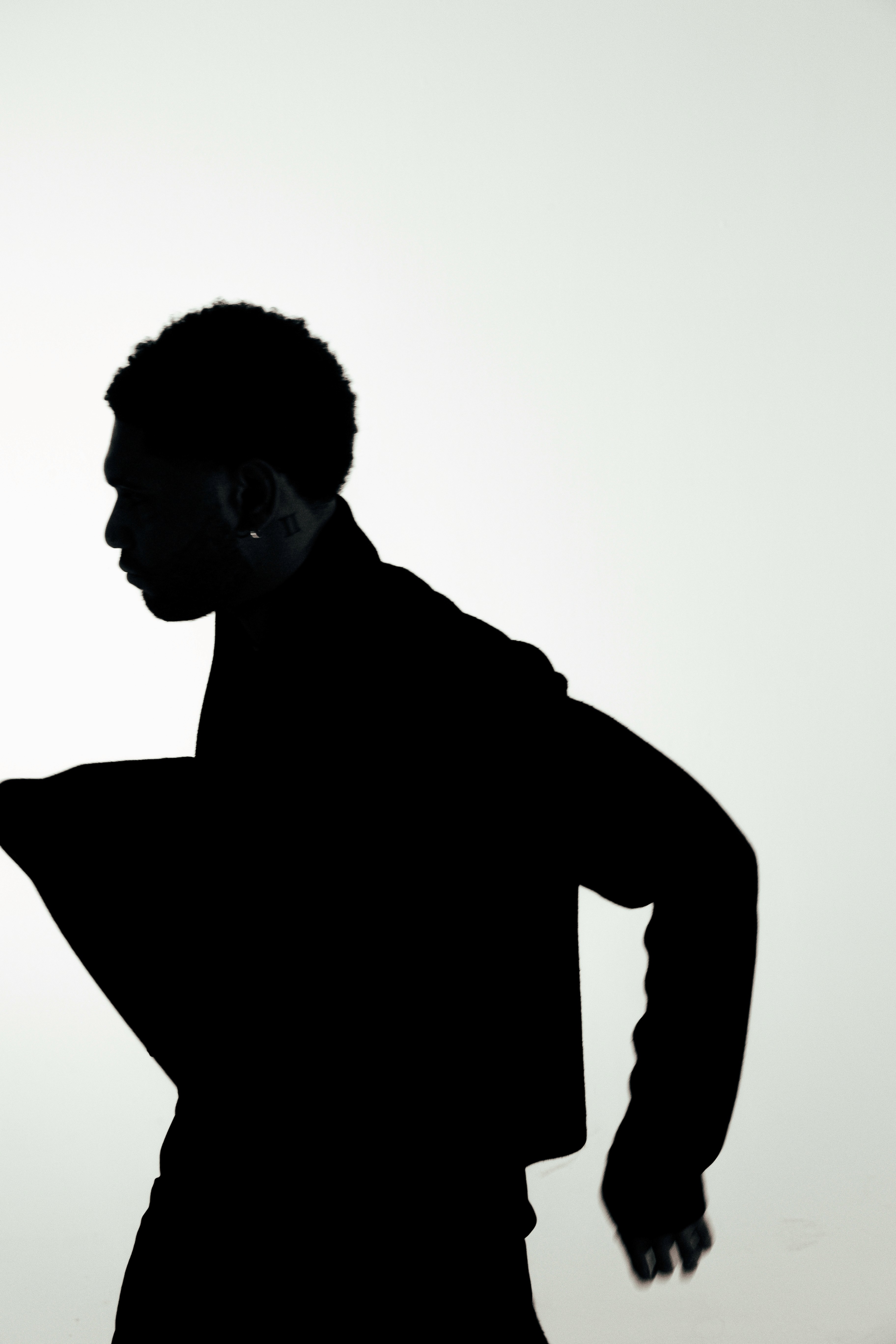 a blurry photo of a person standing in front of a wall