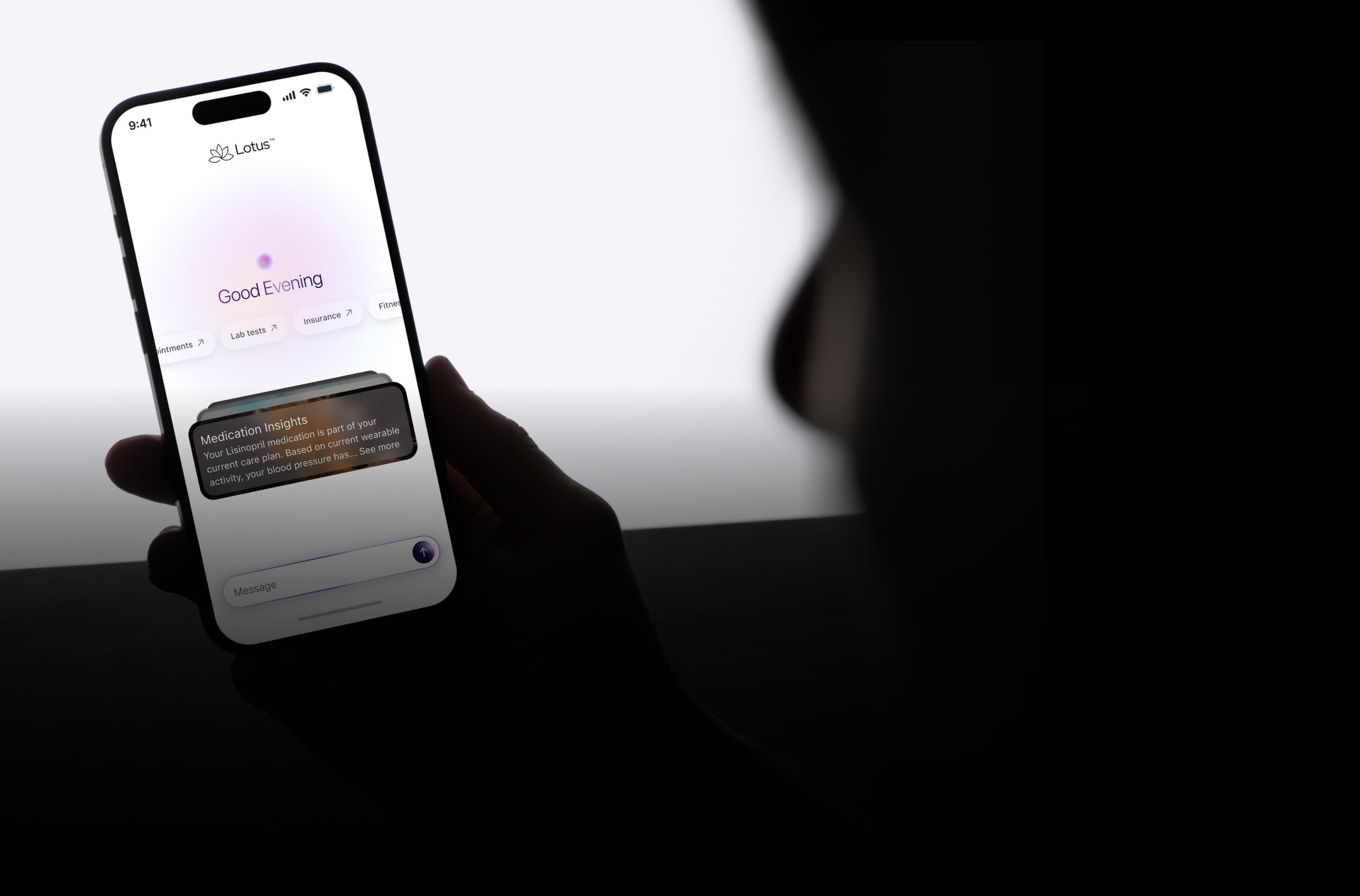 Person holding smartphone displaying Lotus Health AI app home screen with medication insights feature