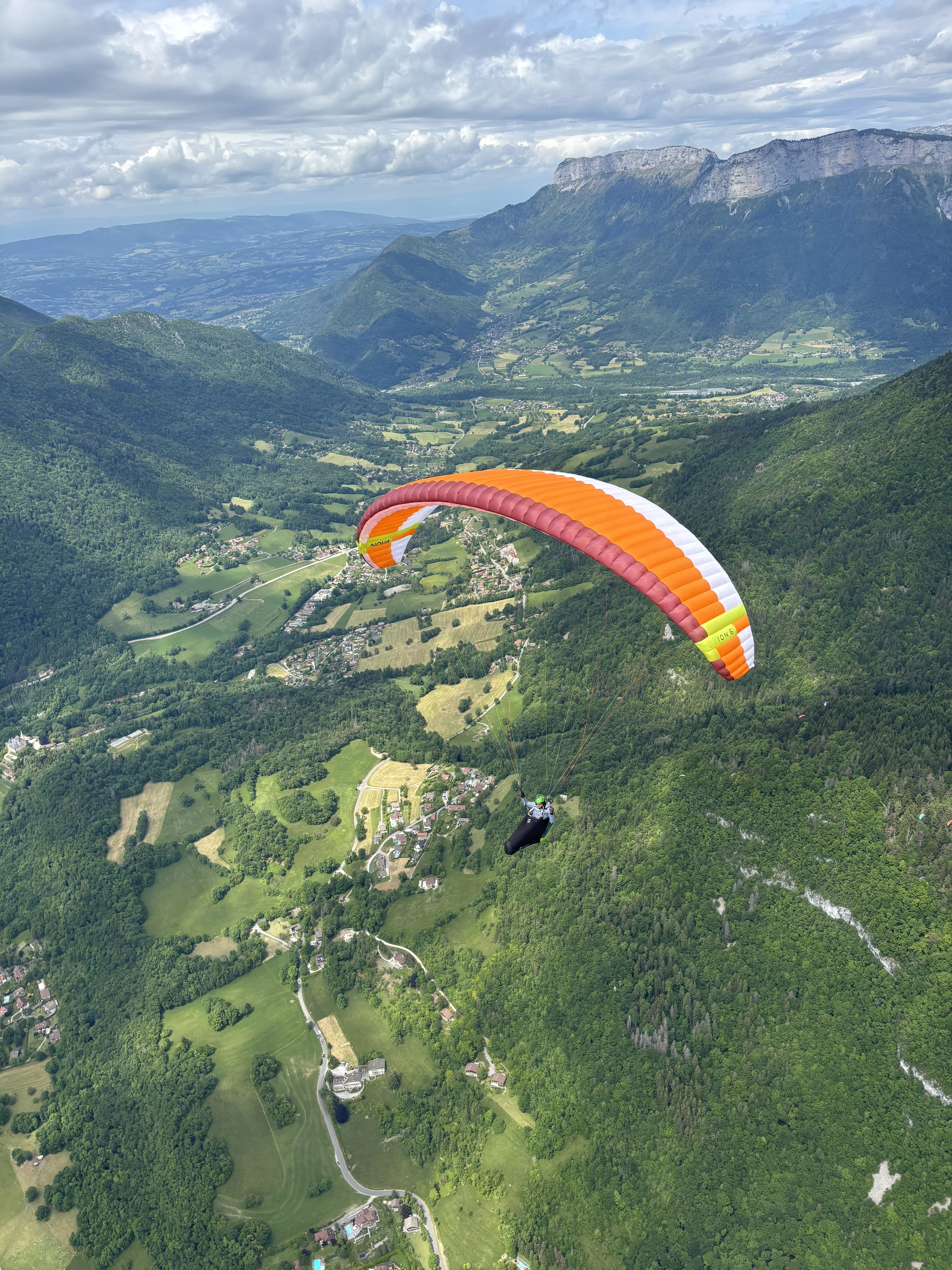 Paragliding pilots flying over mountains