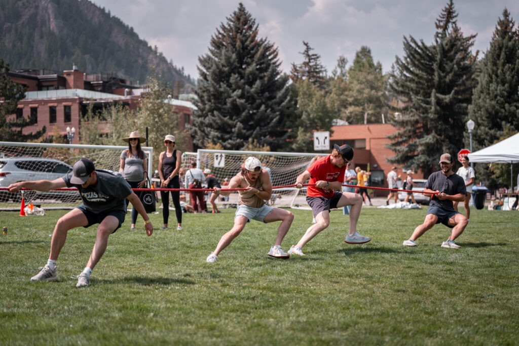 Snowmass corporate retreat photographer capturing a tug of war during an outdoor team activity