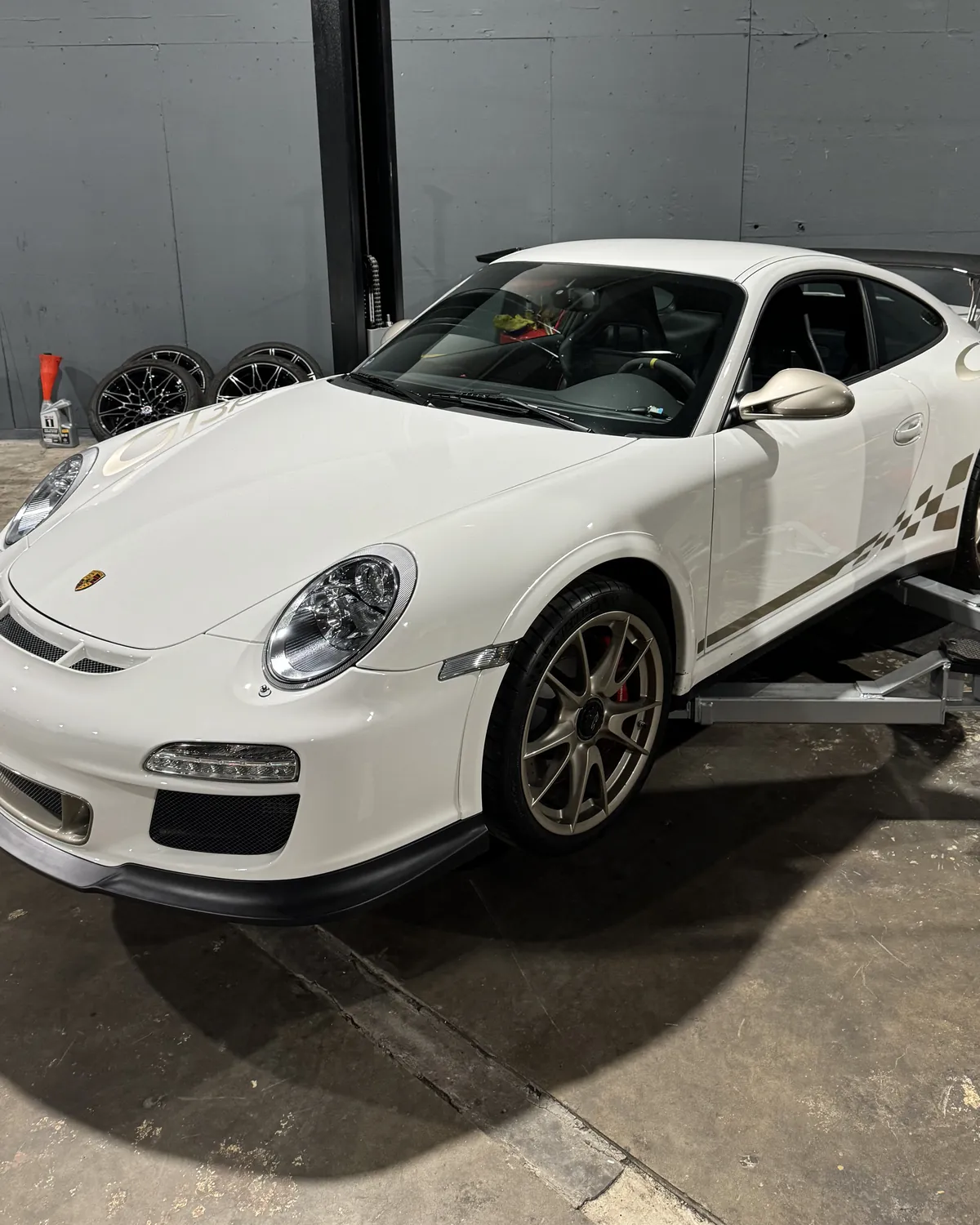 White Porsche 911 GT3 RS on a lift in the 714 Technik service bay