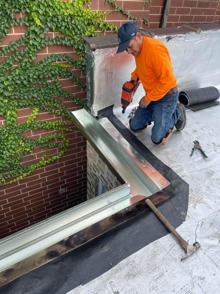 a man in a yellow shirt is working on a roof