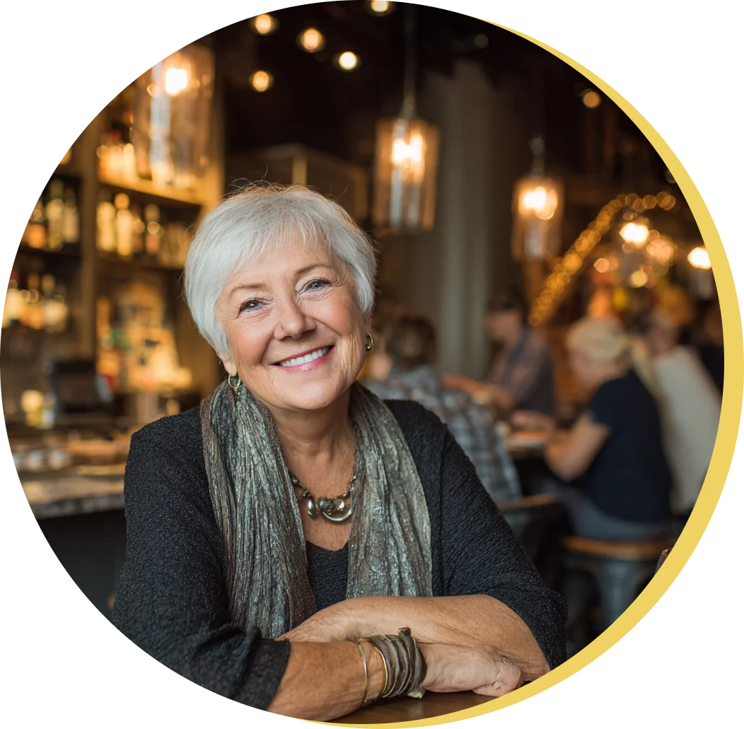 Person smiling and holding a bottle of vitamins in a car.
