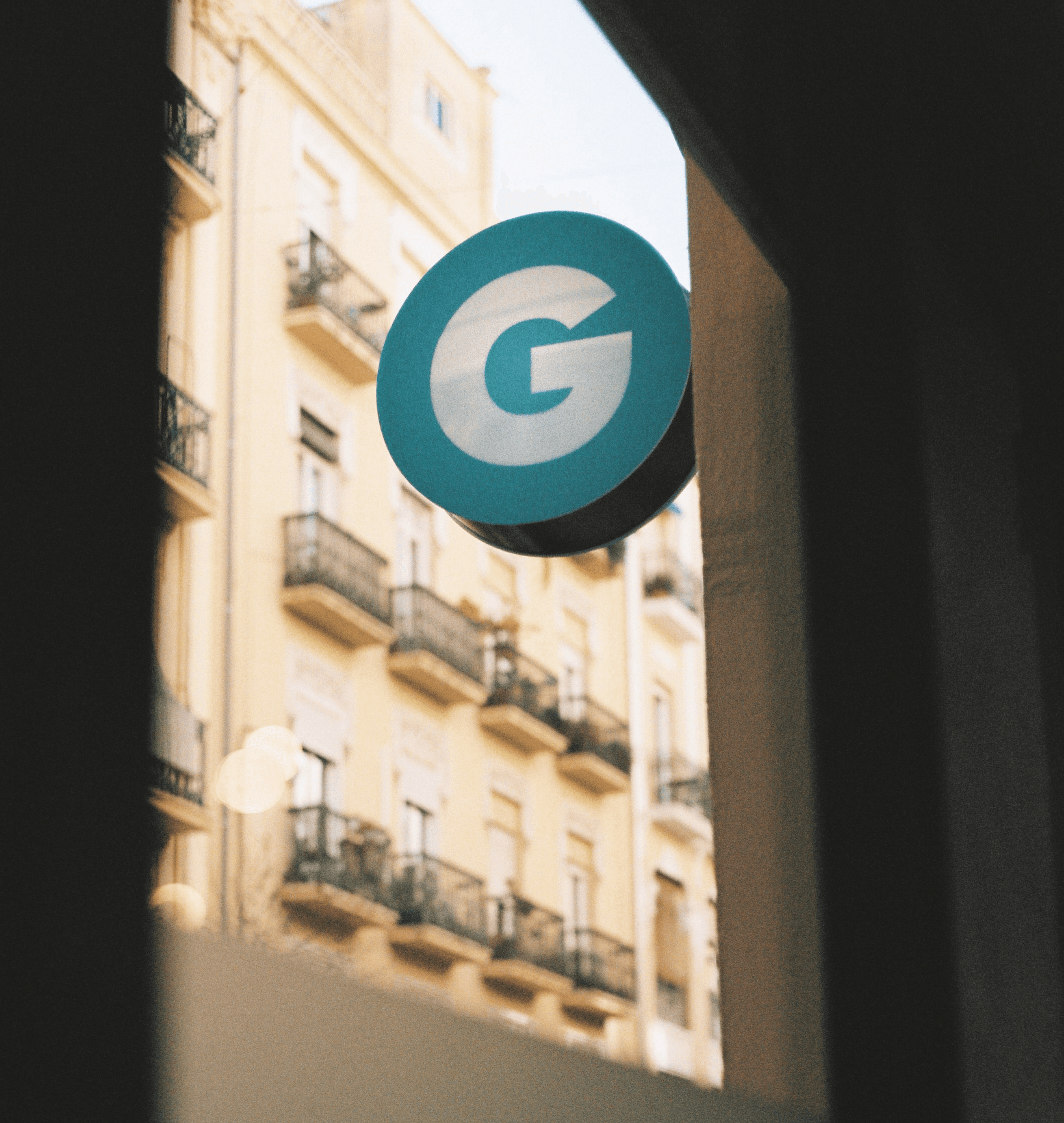 Photograph of the Gusta logo on the sign outside the office.