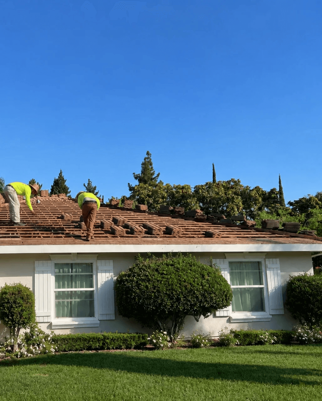 Roofs 4 Less crew repairing a tile roof on a Fresno area residential home