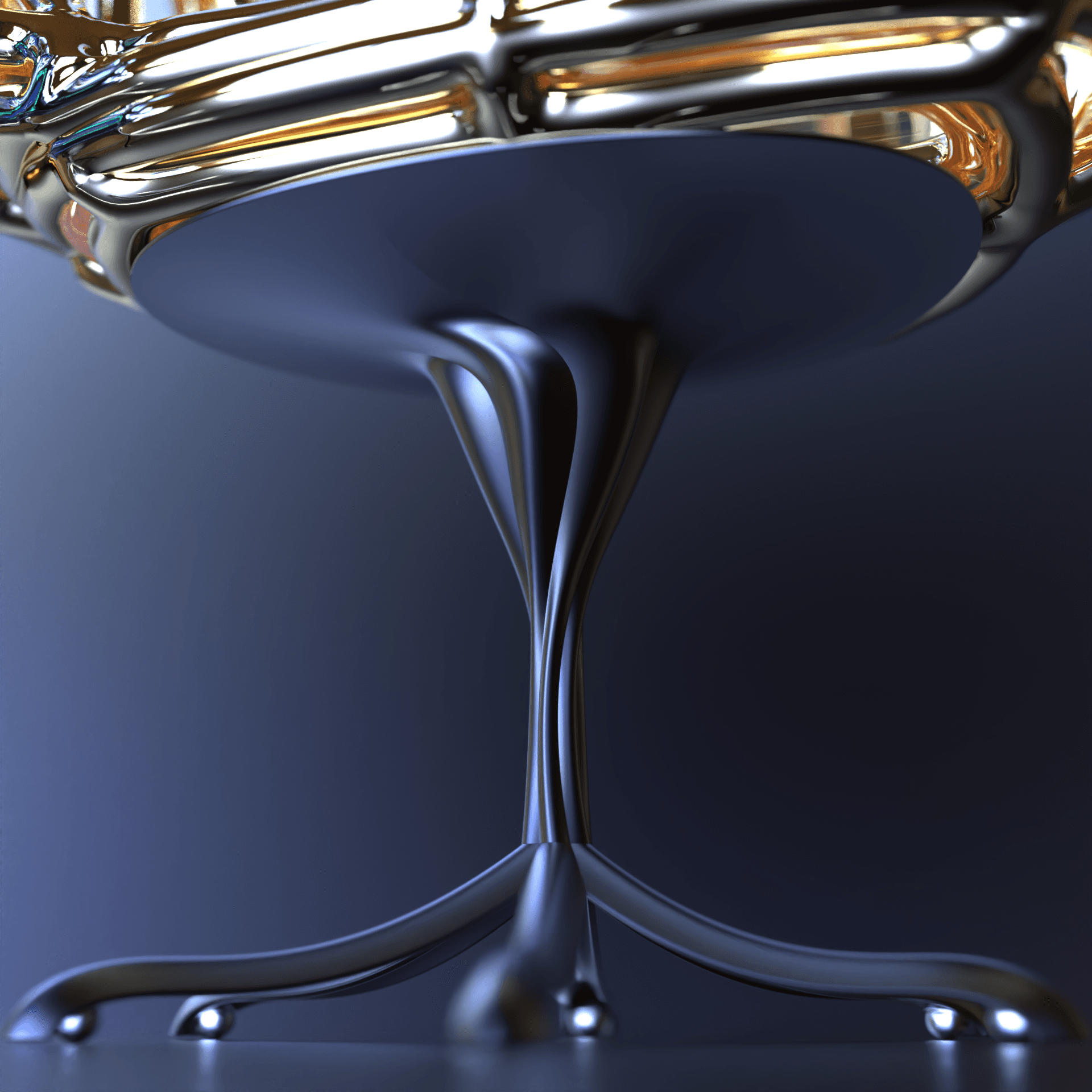 Close-up of a dark sculptural chair base beneath a reflective gold frame