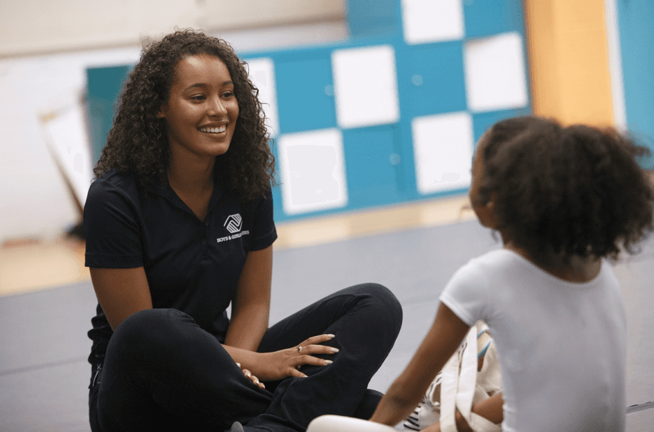 High school student working on academic research with a PhD mentor in a university setting