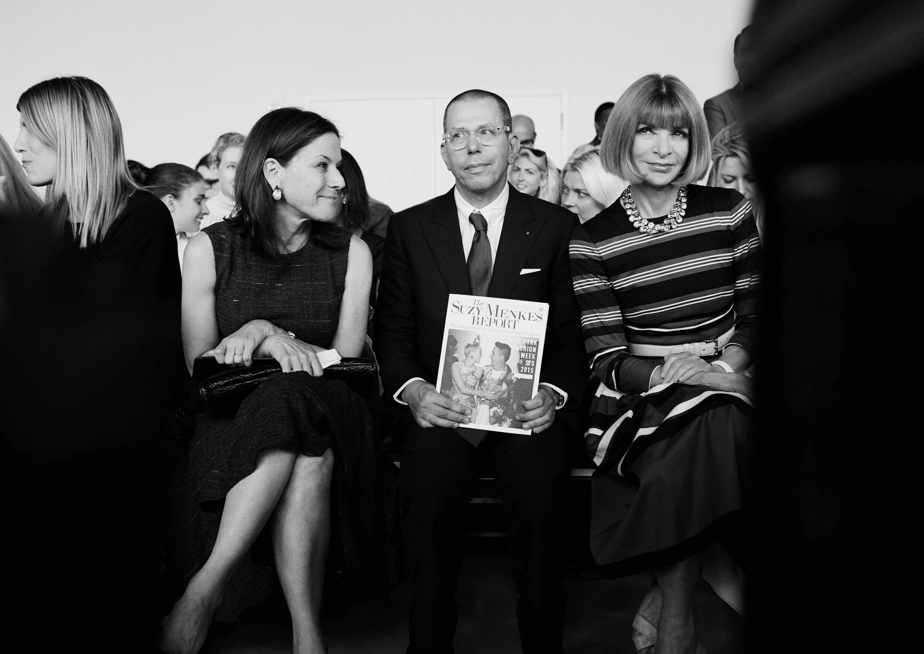 A fast black sports car races down the highway.