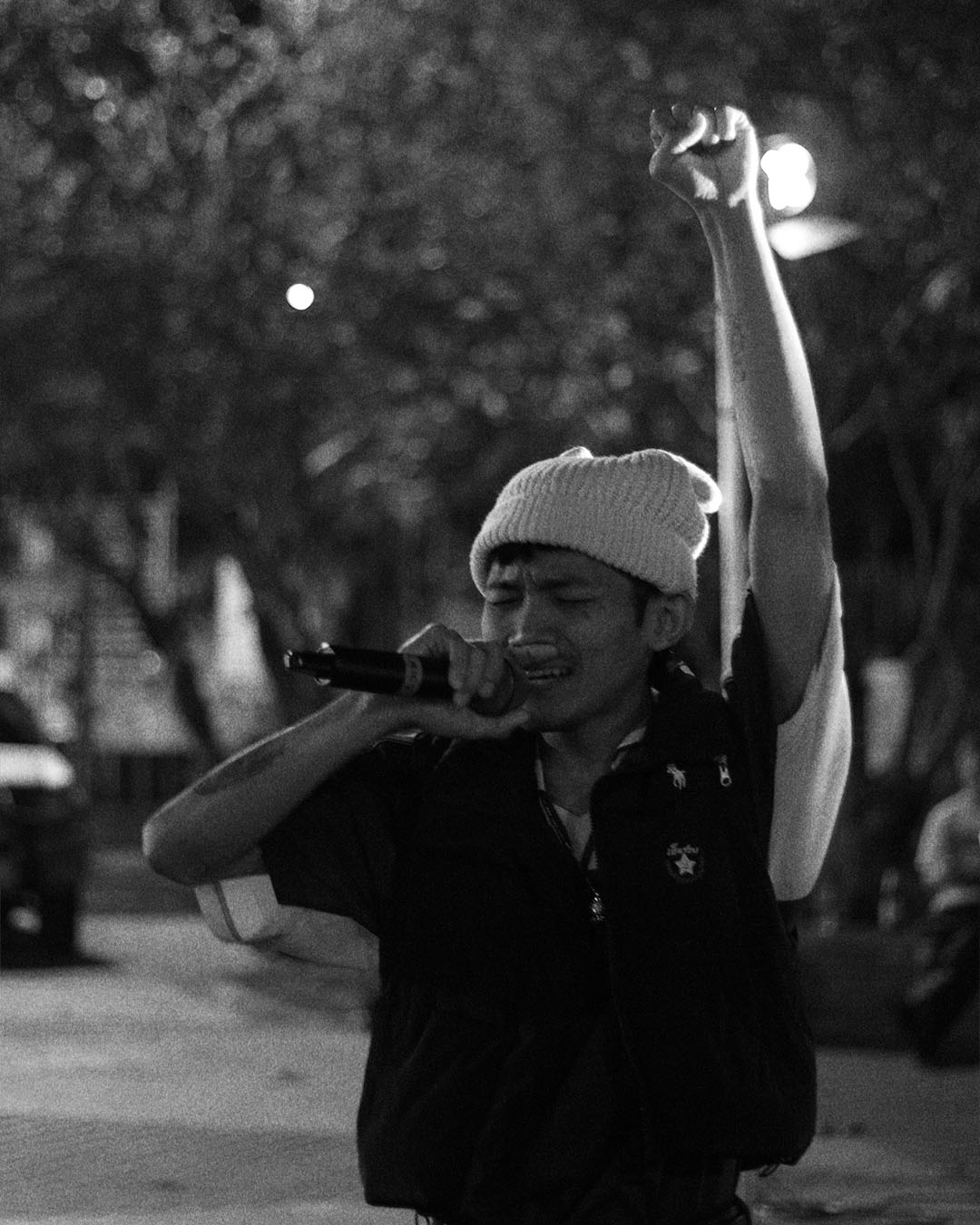 Man wearing sunglasses and headscarf in low light