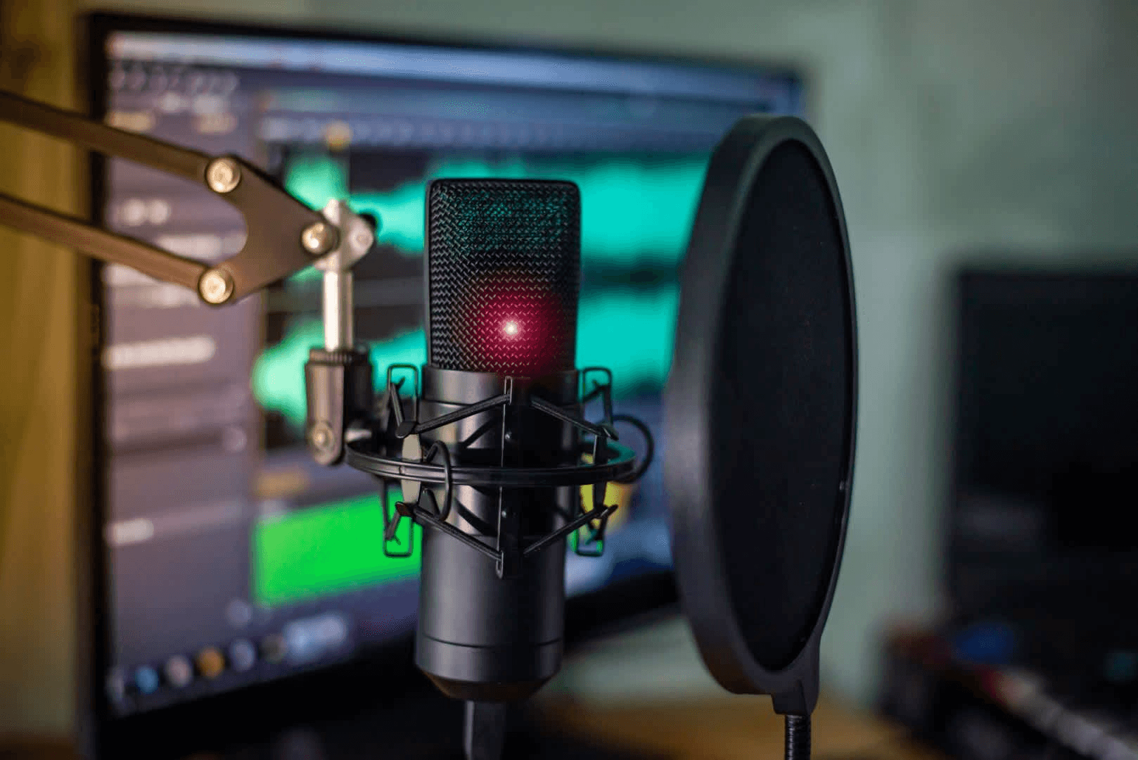 Microphone with pop filter near monitor - Podcast Clips for Social Media