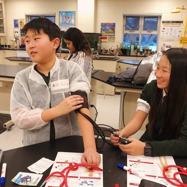a group of people raising their hands in the air