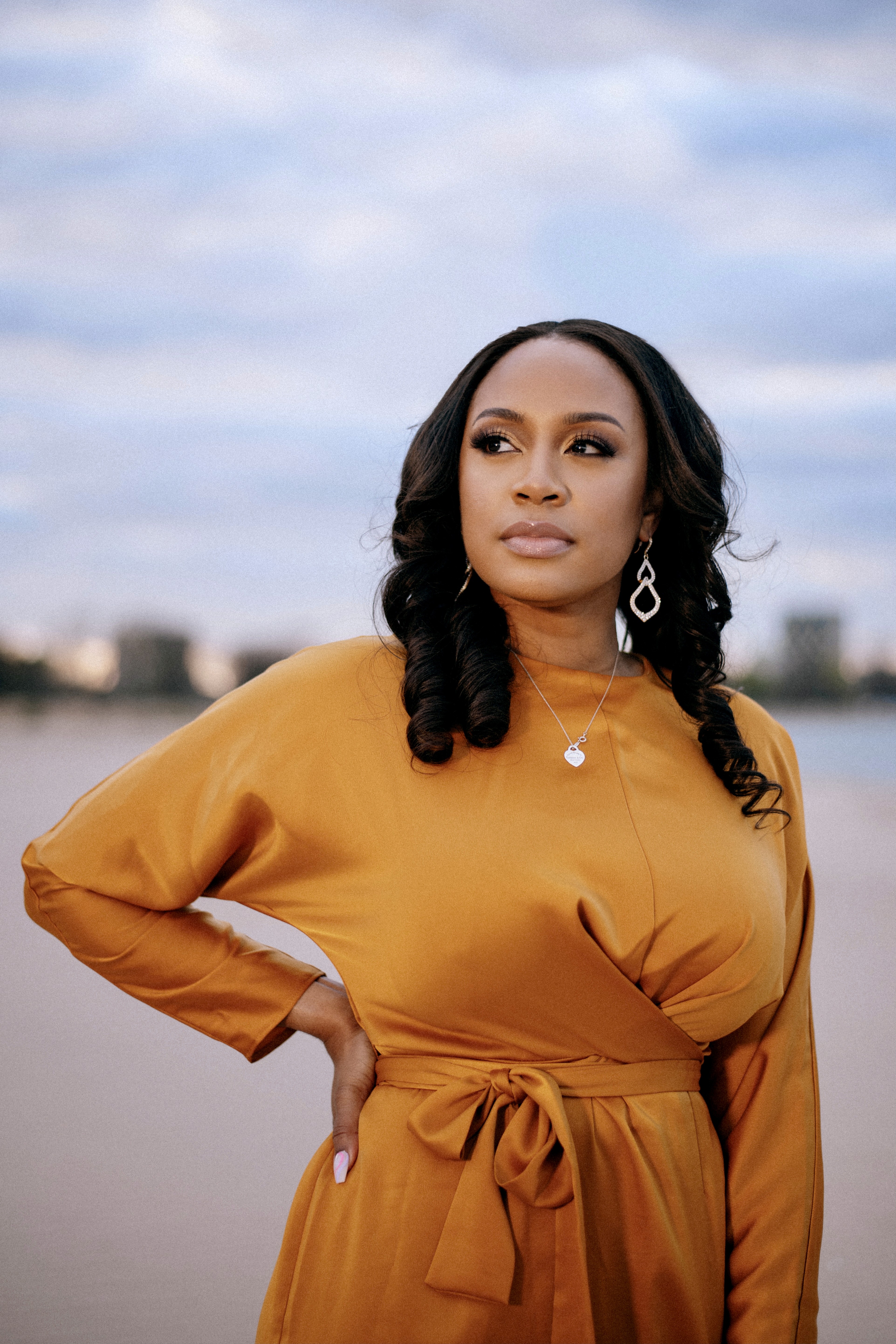Woman in orange dress looking at the horizon