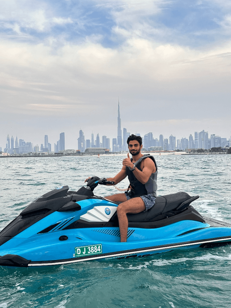 Man riding a jet ski in Dubai with a thumbs-up gesture.