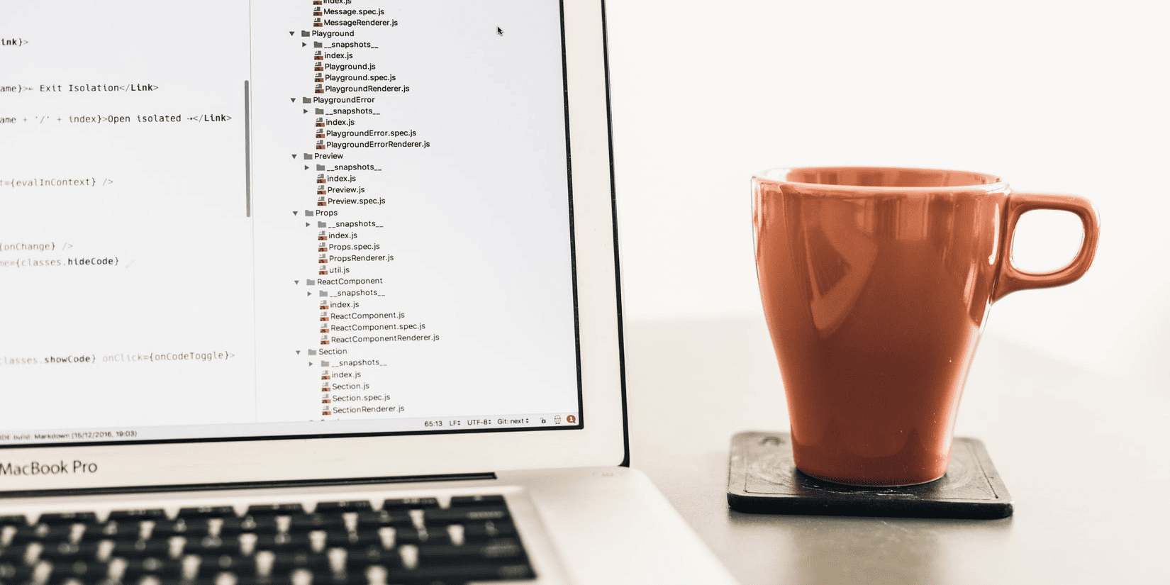 Cup of coffee next to laptop on desk for recruiters showing modern workplace setup