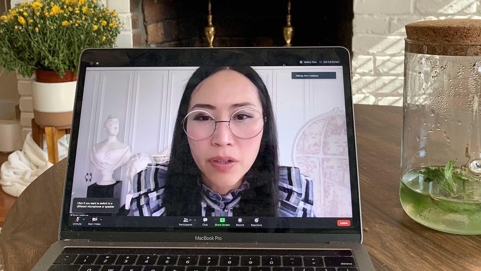 Pum on Zoom call on mac with fireplace & flowers in the background