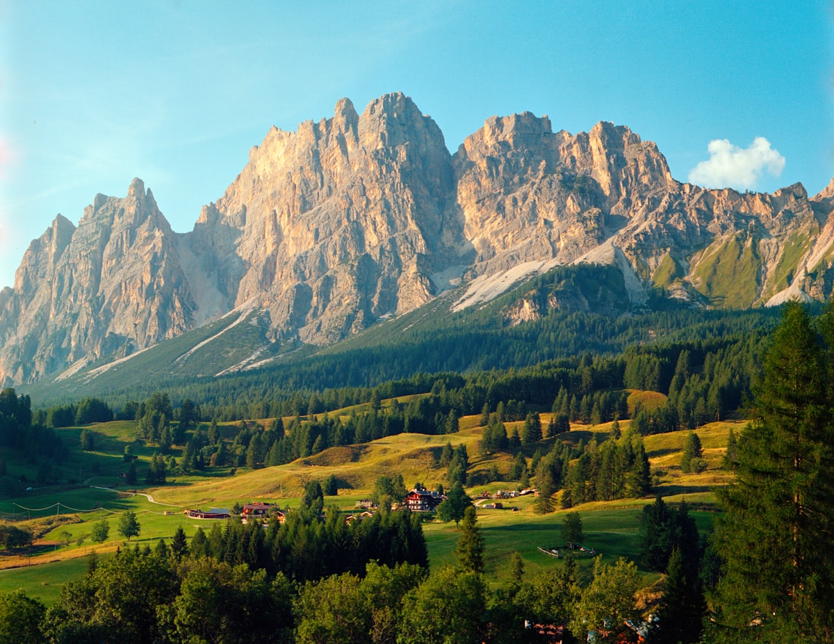 Jagged Dolomites peaks rising above a green alpine valley, a top European coolcation destination