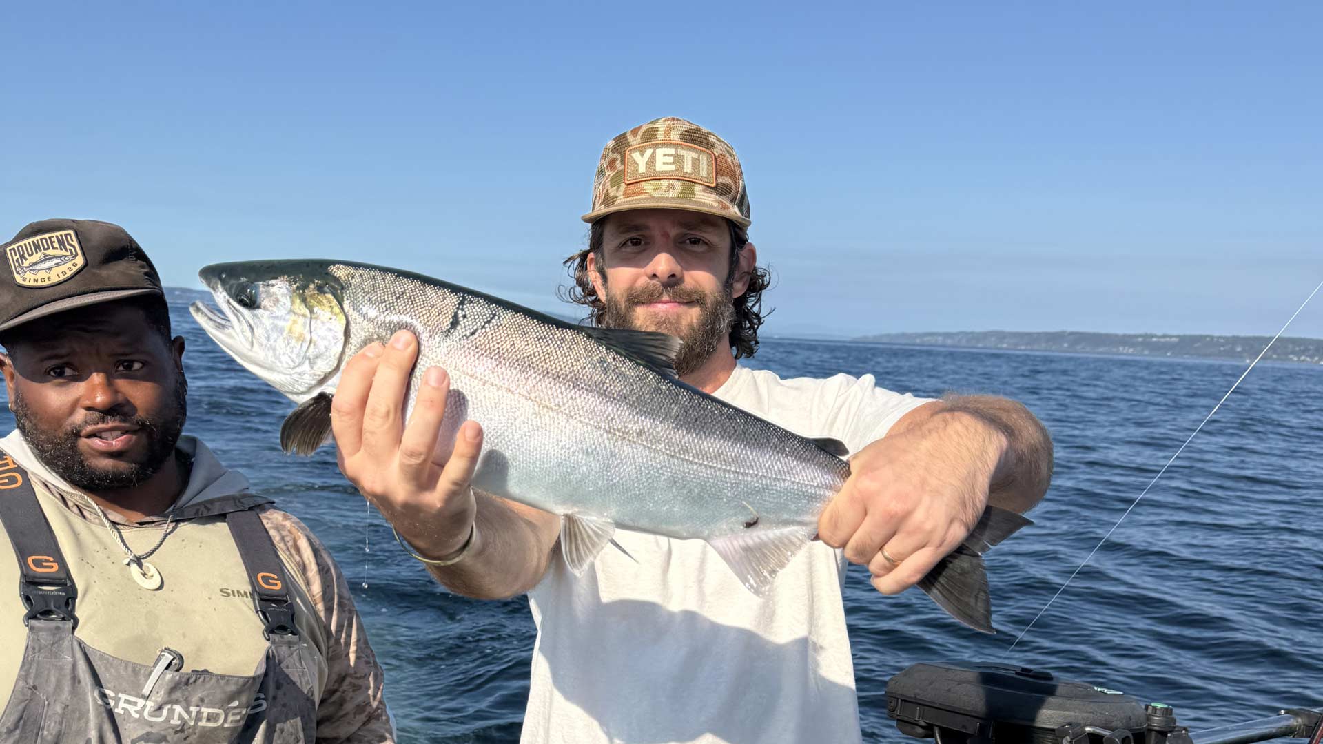 Thomas Rhett holding freshly caught salmon