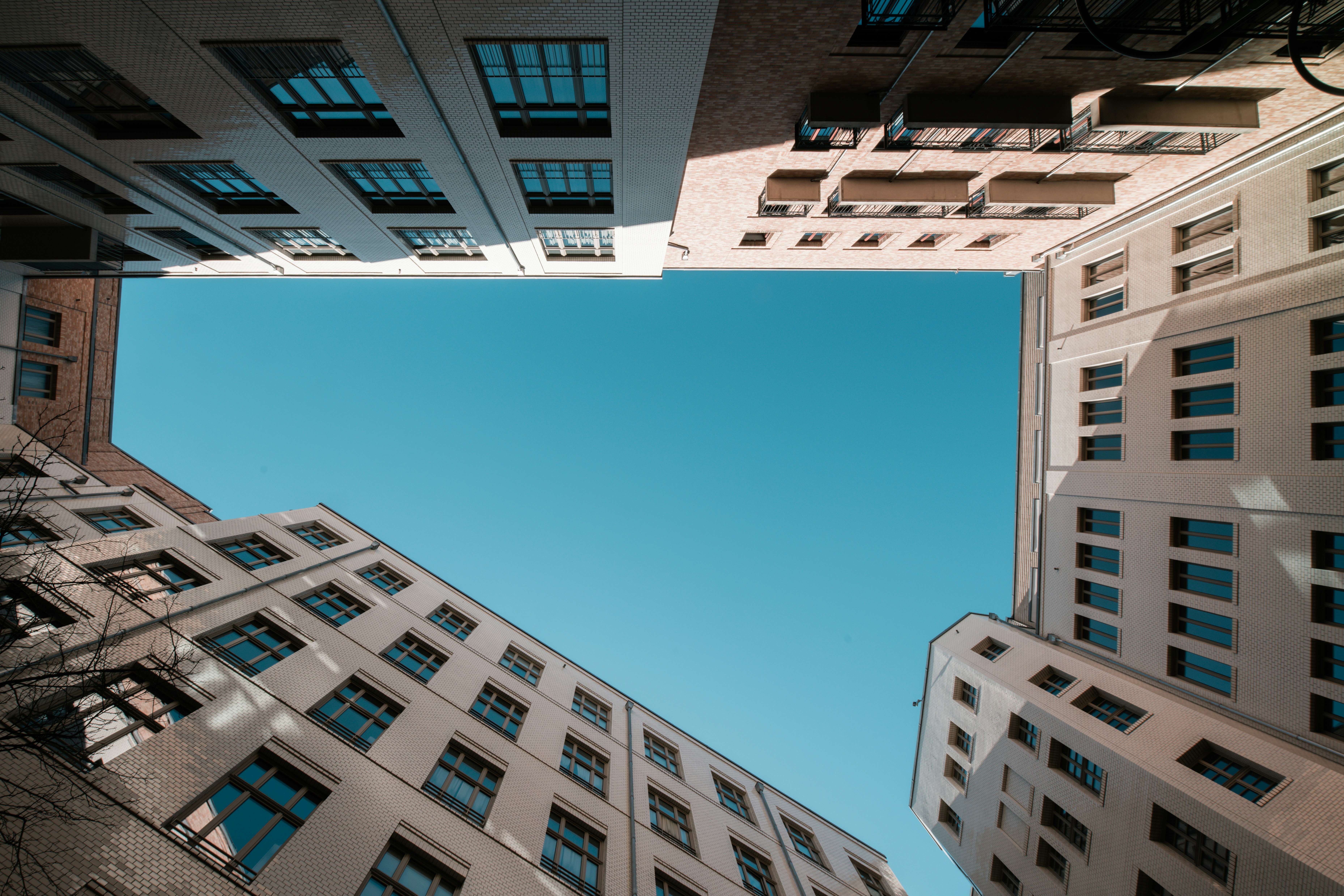 Buildings surrounding a bright blue sky