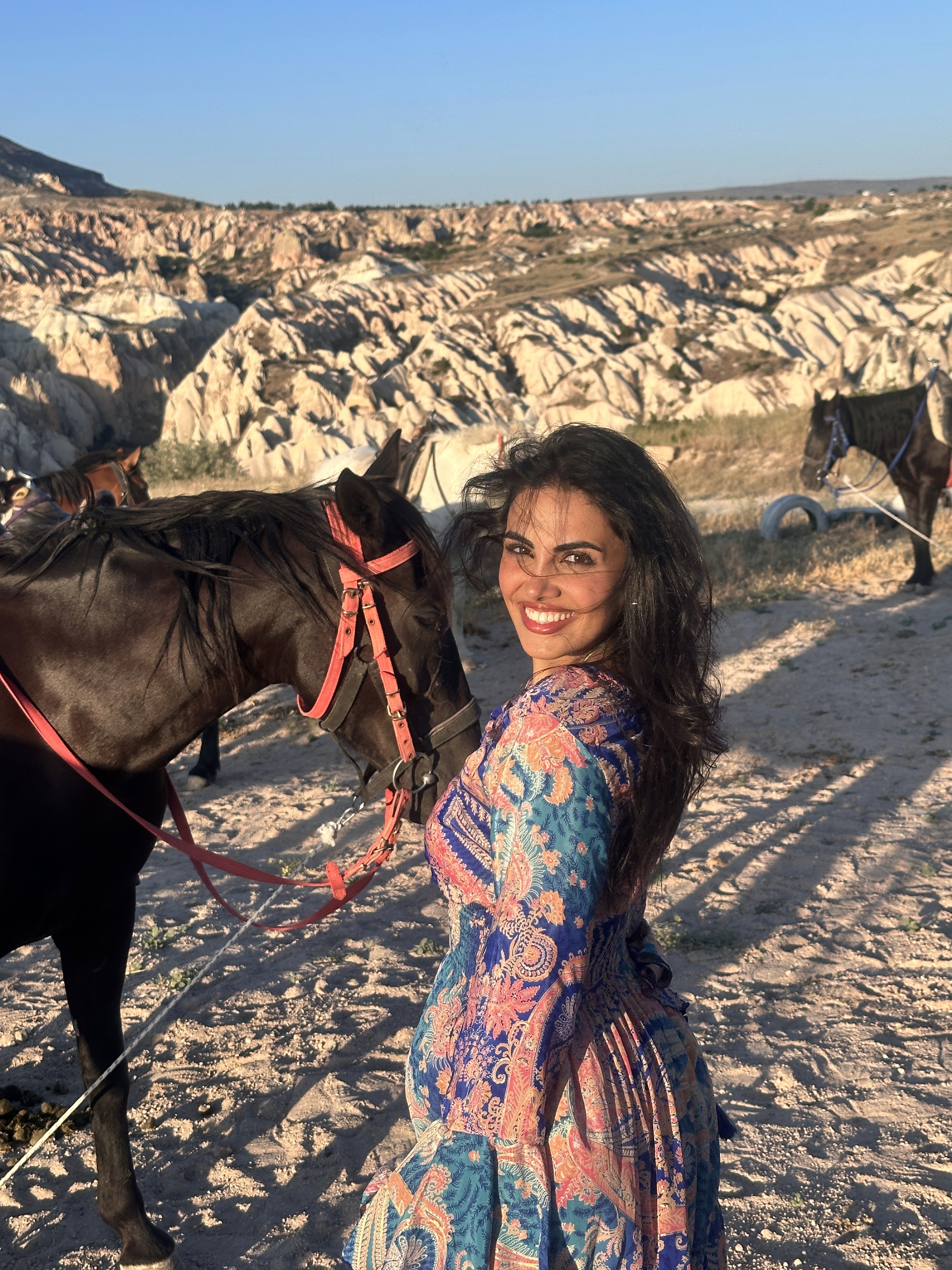 Two people talking on a rooftop at sunset