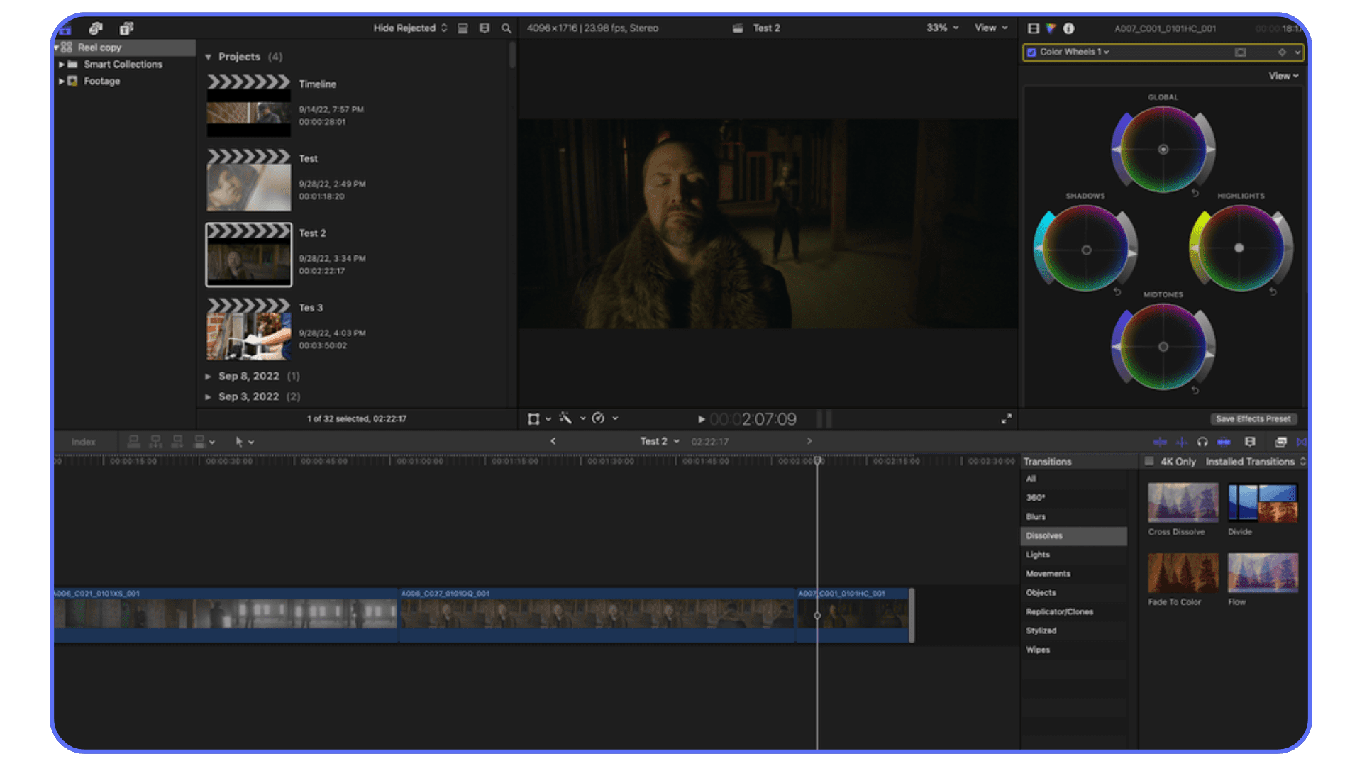 Final Cut Pro workspace with color grading wheels and a video clip of a bearded man in dim lighting on the timeline.