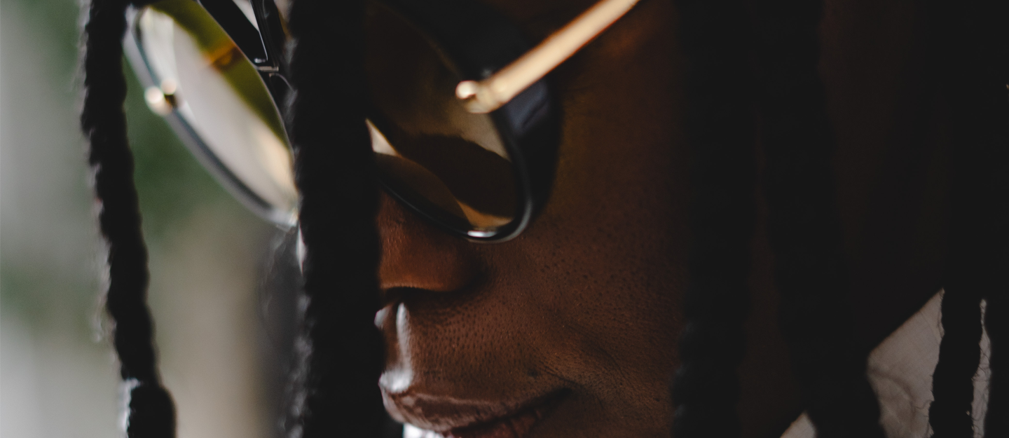 Zoomed in on Dali Adekunle with glasses and creative showcase of showcasing portfolio