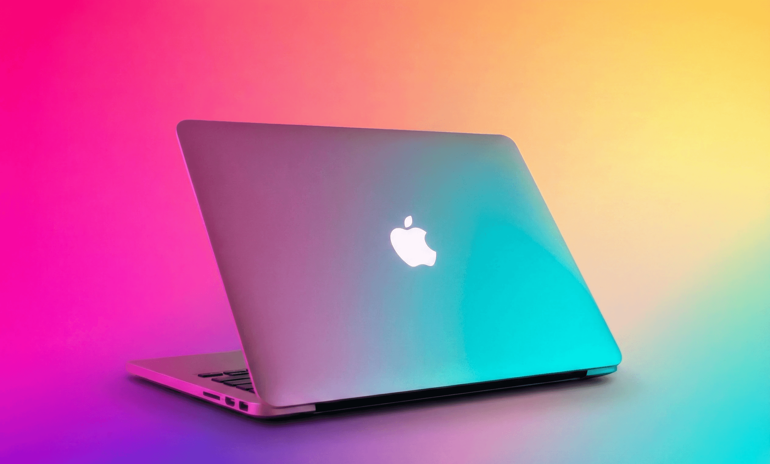 silver macbook on white table