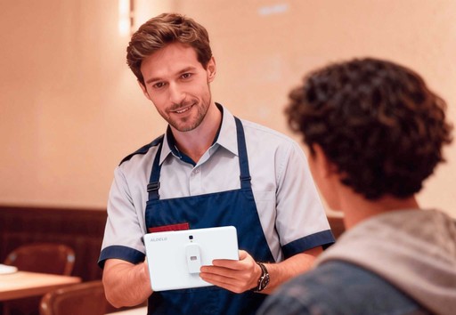 Aldelo ePay male clerk using it in front of a customer.